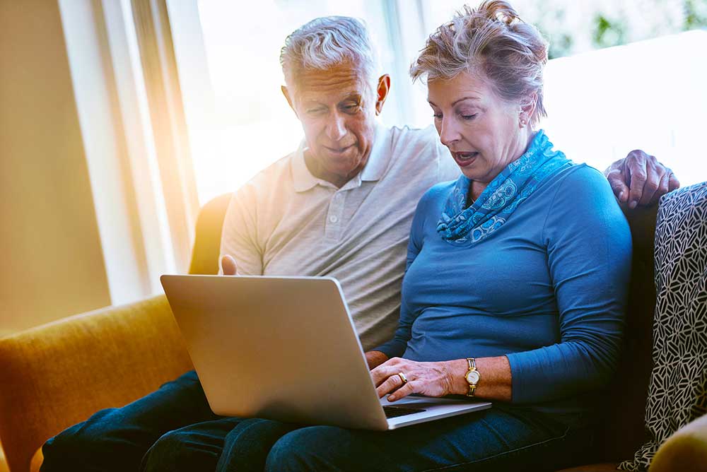 Senior couple reading Minuteman Medical's website FAQ page
